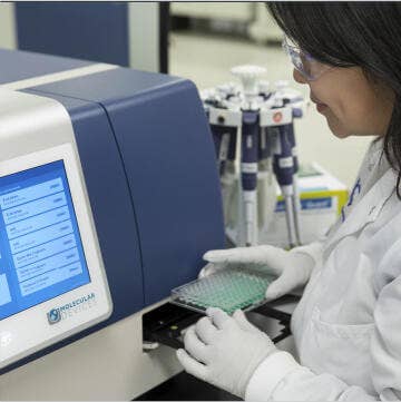 Scientist working on Microplate Reader